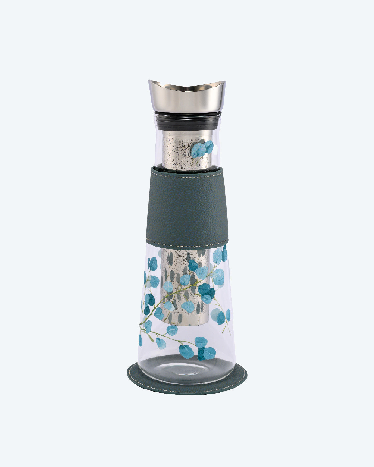 Tall, elegant, clear glass carafe, including removable tea strainer and stainless steel pour top, decorated with painted eucalyptus leaves in light blue on thin green stalks, including sleeve for grip and matching base.